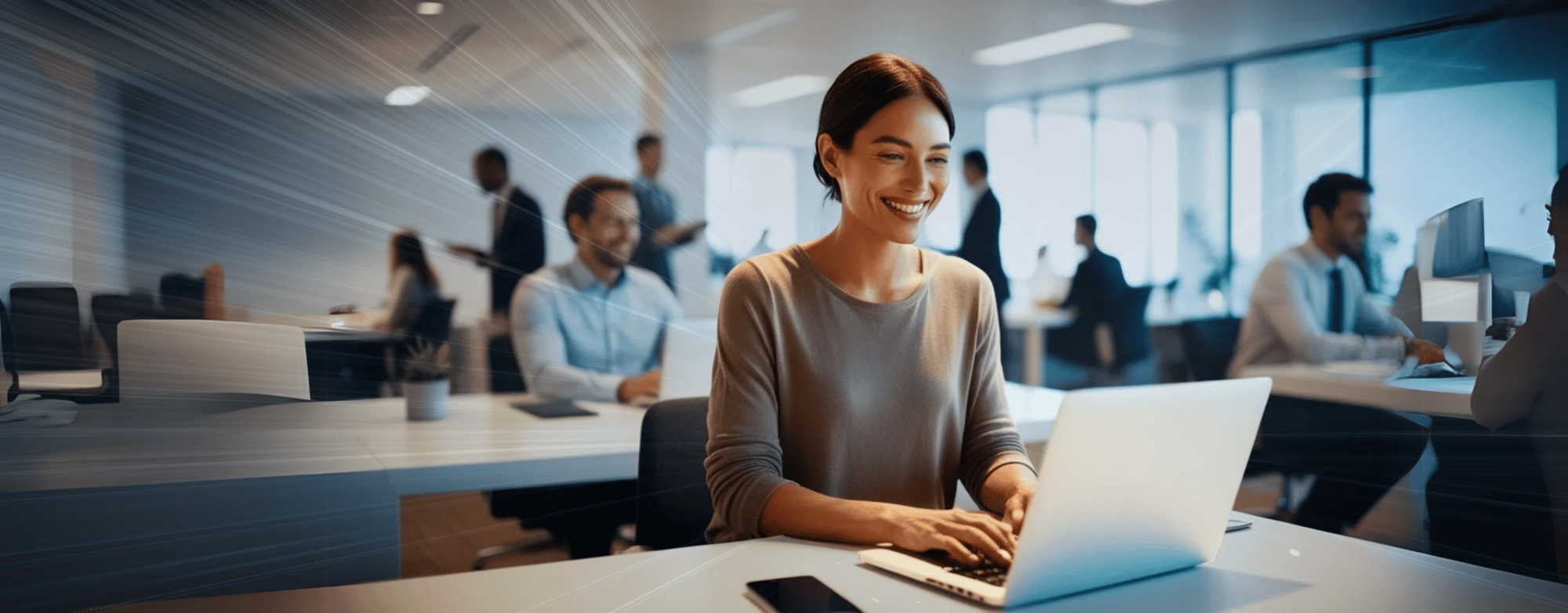 modern office worker at laptop smiling with bright lights